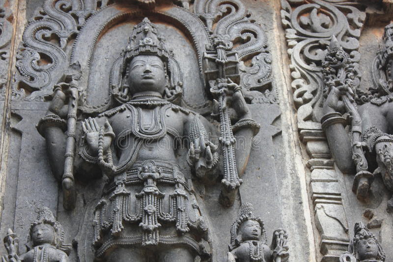 hoysaleswara-temple-wall-carved-sculpture-lord-shiva-holding-pine-cone-temple-wall-carved-sculpture-lord-98627224.jpg